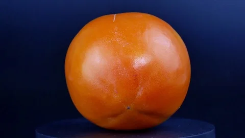 Persimmon spins on a black background.1 Stock Footage 123179861