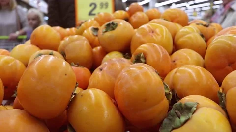 Persimmon in the store. Fresh persimmon on the background of the store. 스톡 동영상 220796279