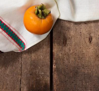 Persimmon on the table Stock Photos