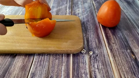 Persimmon on the wooden background Stock Footage 227721919