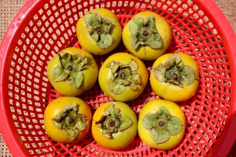 The persimmons in the basket Stock Photos