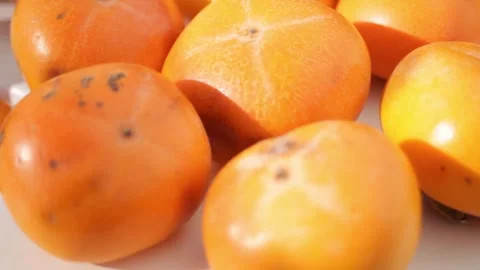 Persimmons close-up on the surface of the table after harvesting. Stock Footage 297461127
