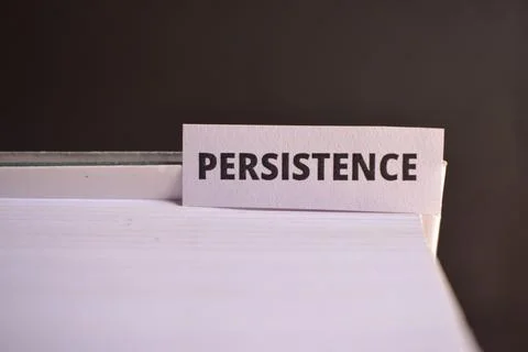 Persistence Paper Tab Between Book Pages for Commitment, Success and Person.. Stock Photos