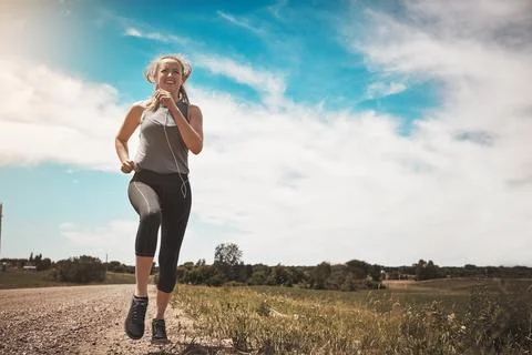 Persistence will allow me to conquer today. a young woman out on a trail run. Stock Photos