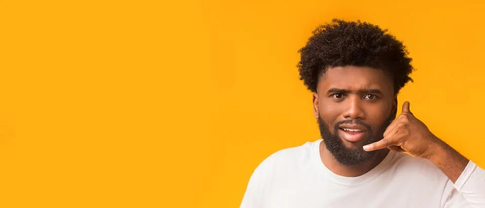 Persistent afro guy showing call me gesture over orange background Stock-Fotos
