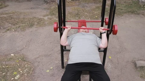 A persistent fat man lifts weights Stock Video Pond5