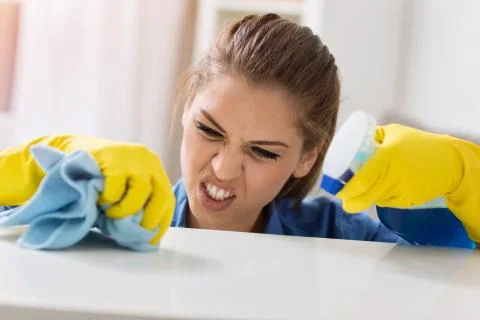 Persistent girl cleaning the table Stock Photos