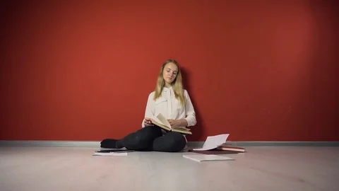 Persistent Young Student Girl Studying on Floor 動画素材 69966542