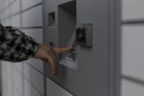 A person is actively pressing a specific button located on a machine Stock Photos