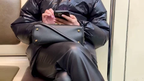 Person is actively using their smartphone while comfortably seated on a mode of Stock Footage 316468800