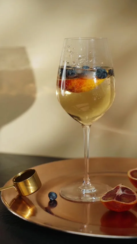 A Person Adding Blueberries in Champagne: A Refreshing Twist Stock Footage 300021601
