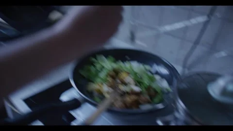 Person Adding Salt to Homemade Stirfry in Kitchen Video stock 341813596