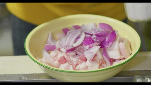 Person Adding Salt to Meat and Onion Mixture in Bowl Stock Footage 330704592