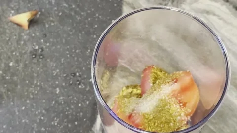 A person is adding spices to a blender full of tomatoes 스톡 동영상 279052938