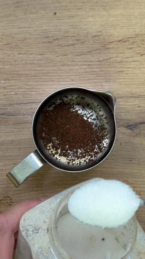 Person adding sugar to instant coffee grounds Stock Footage 339603418
