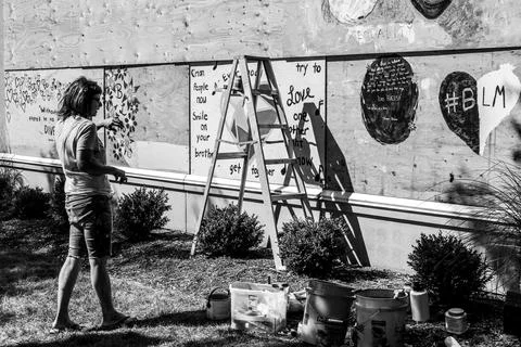 Person adding to wall of art Stock Photos