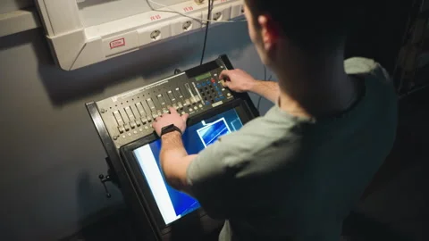 Person adjusting digital panel controls in studio workspace Stock Footage 317552806
