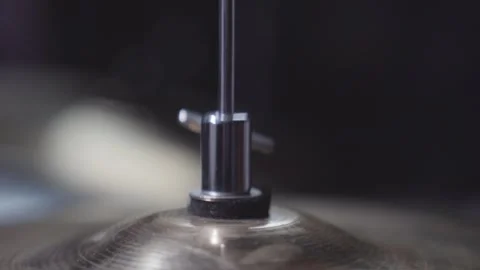 Person adjusting height screw on drum set's hi-hat cymbal. Close up on Stockbeeldmateriaal 240183618