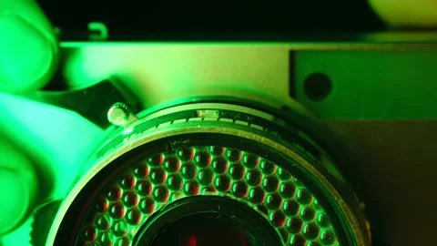 Person adjusting lens shutter speed on vintage camera Stock Footage 321736342