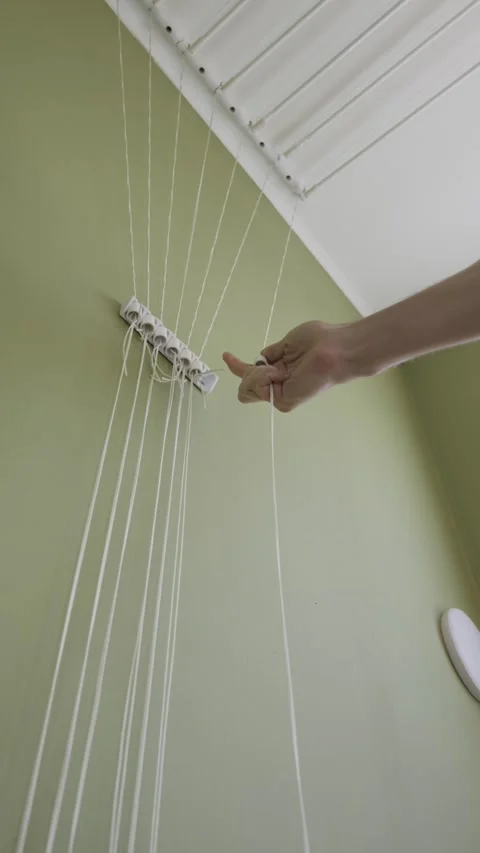 Person Adjusting Strings Of Ceiling Mounted Laundry Drying Rack 스톡 동영상 329972670