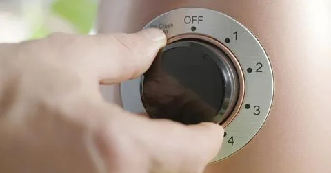 Person adjusts setting on a device at home Stock Photos