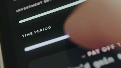 Person adjusts the Time Period within an investment calculator Video stock 332486780