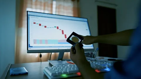 Person analyzing cryptocurrency market on computer with magnifying glass Stock Footage 315982060