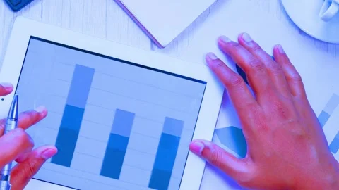 Person analyzing financial charts on tablet computer screen Stock-Footage 342906183