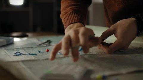 Person analyzing a map with markers and tools for planning and navigation Stock Footage 301406506
