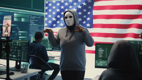Person in anonymous mask working on intelligence in a governmental hacking room Stock Footage 277671139