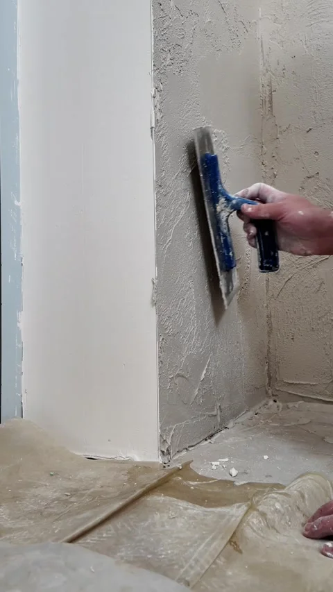 A person applies a smooth layer to a wall in a home. Stock Footage 339019507