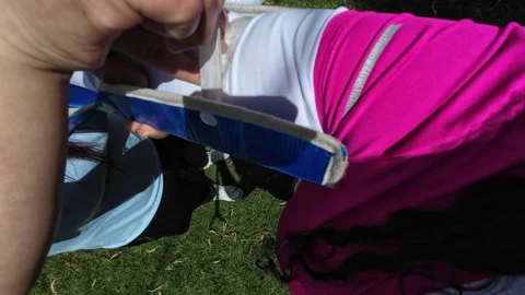 Person applying first aid splint to an injured arm outdoors Video stock 345169385