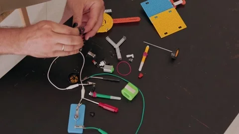 Person assembling educational robotics kit on a table Stock Footage 322180596