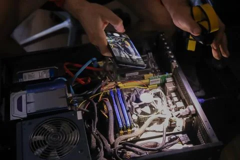 Person assembling high performance gaming computer with liquid cooling Stock Photos