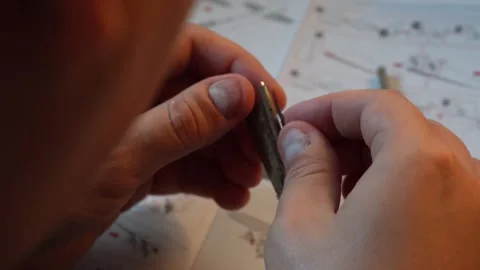 Person assembling metal airplane model with hands Stock Footage 319294139