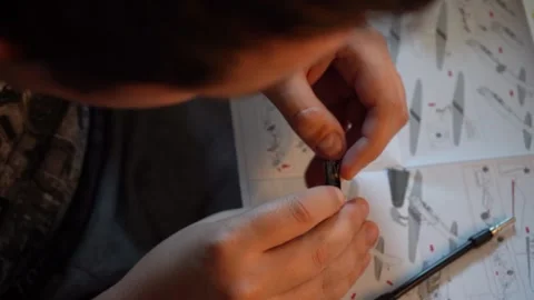 Person assembling metal airplane model with hands Stock Footage 319294223