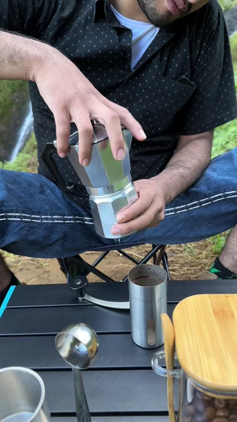 Person Assembling Moka Pot Coffee Maker at Outdoor Campsite Close Up Video stock 323907182