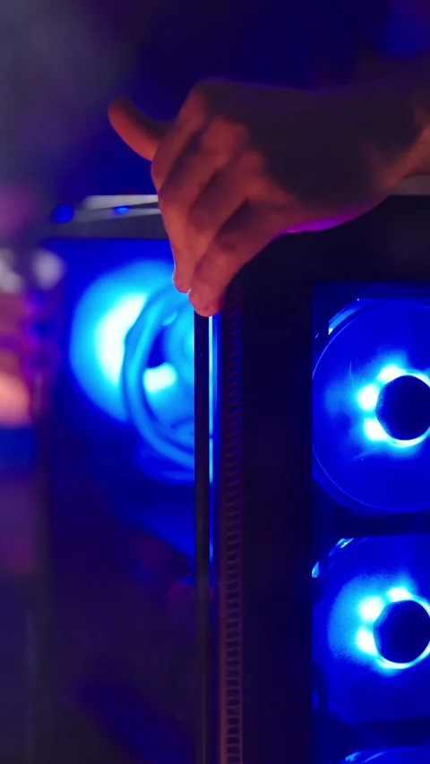Person assembling smoking hot gaming RGB computer glass panel Stock Footage 324131735