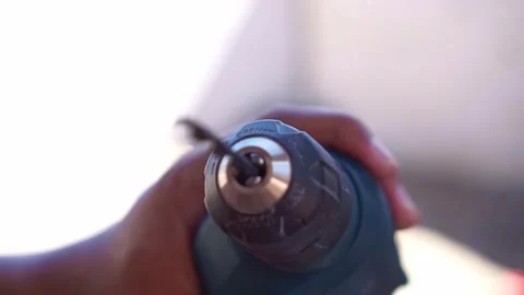 Person attaching drill bit to electric drill chuck, close up shot, hardware Stock Footage 345869485