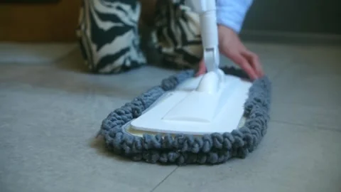 Person attaching microfiber mop head to floor cleaner Stock Footage 318898410