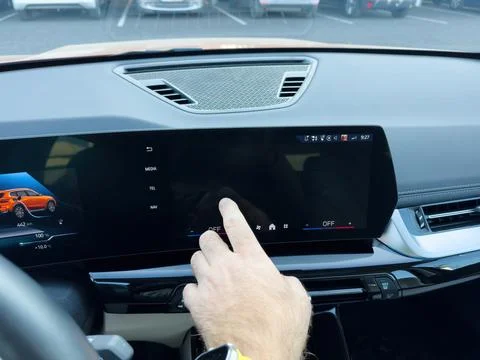 A person attempts to interact with an unresponsive touchscreen infotainment Stock Photos