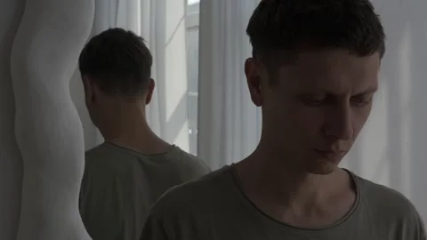 Person avoids mirror reflection, symbolizing self-denial and mental struggle Stock Footage 311763003
