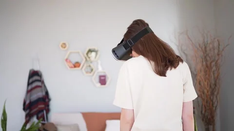 A person from the back in a VR headset. Internet-connected technology for Stock Footage 150556362