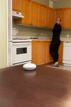 Person in background using their smart speaker Stock Photos