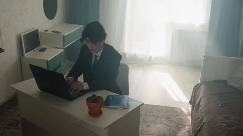 Person balances multiple roles in sunny living space at night. Dedicated worker Stock Footage 342059390