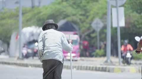 Person Begging Along a Roadside Stock Footage 345618887