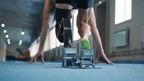 Person with bionic prosthesis stands in a pose and starts to run, back view. Stock Footage 100833872