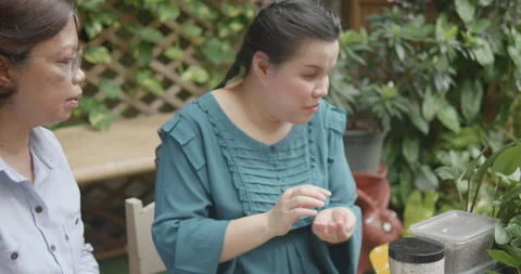 Person with blindness disability learning about growing media in gardening Stock Footage 323447335