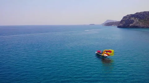 Person On Boat Pull To Fold The Colorful Canopy After Parasailing Activity 库存影片 202006053
