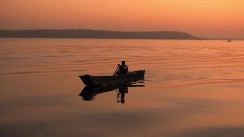 Person Boating on a Lake at Sunset (Slow Motion Video) Stock Footage